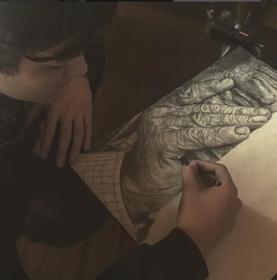 Drawing a study of hands in pencil.